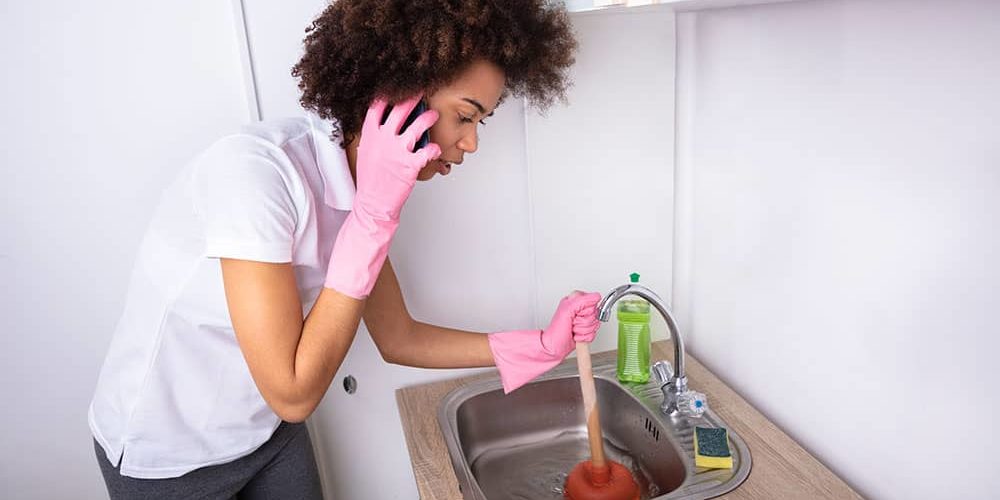 person at home plunging sink