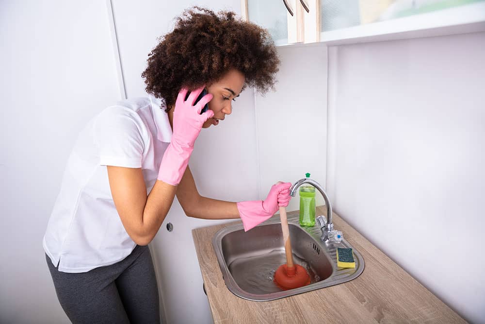 person at home plunging sink